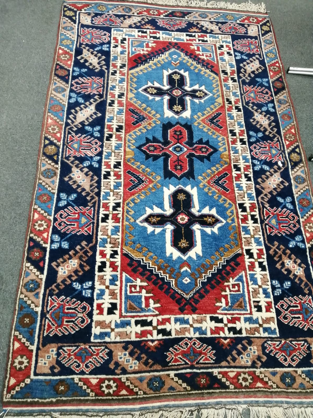 A Caucasian blue ground rug, 200cm x 118cm